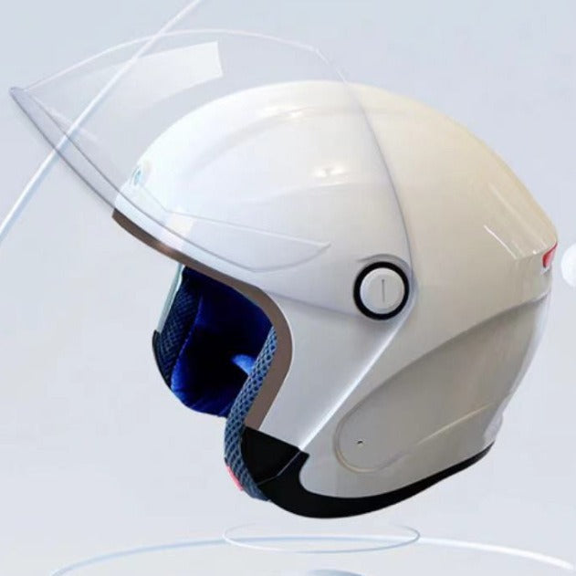 White motorcycle helmet with clear visor on a light gray background