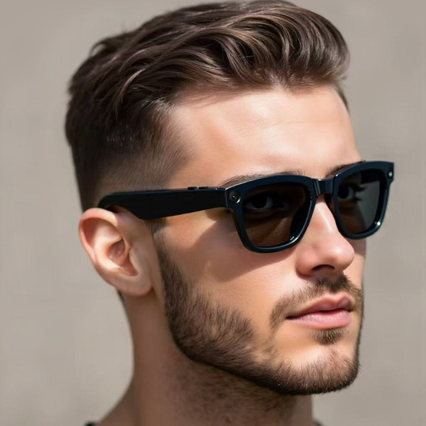 Man wearing black sunglasses with a neutral background